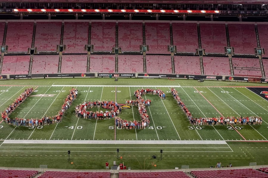 Picture of students forming the letters spelling out UofL